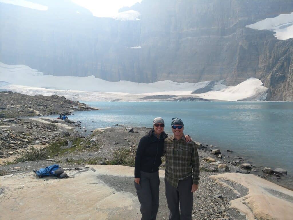 selfie of a couple at the Grinnell Glacier summit in Glacier National Park